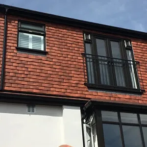 A red brick building with a white and black roof.